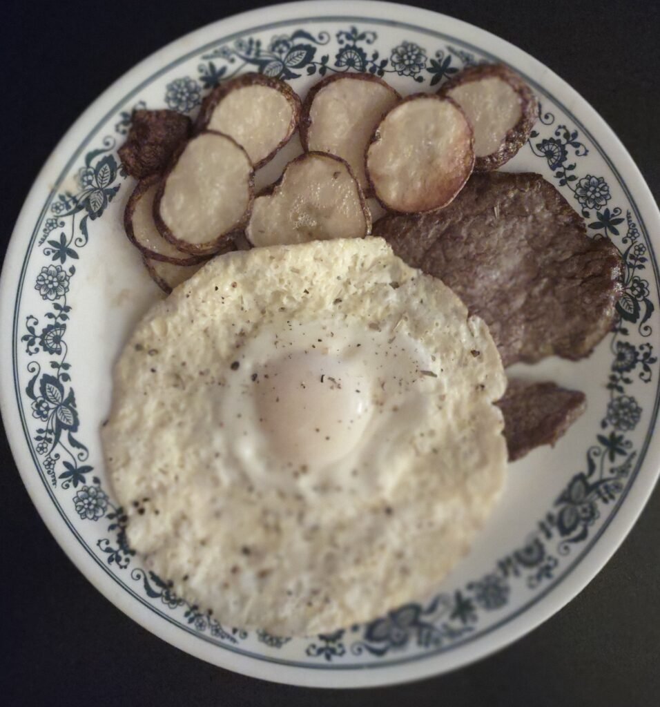 steak, dippy eggs and fried potatoes