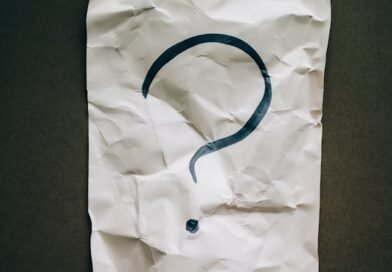Crumbled paper with a hand‑written question mark