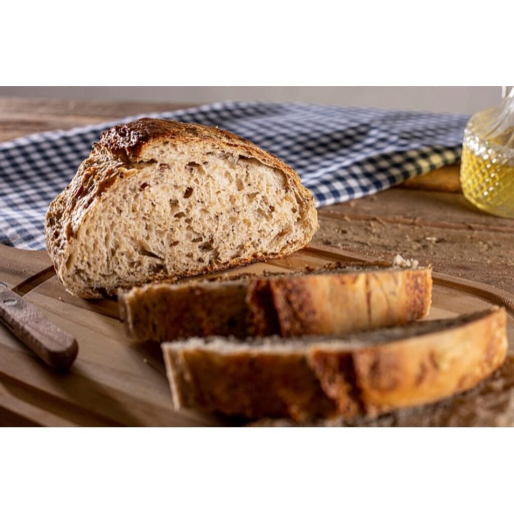 Sliced homemade bread on a wooden cutting board