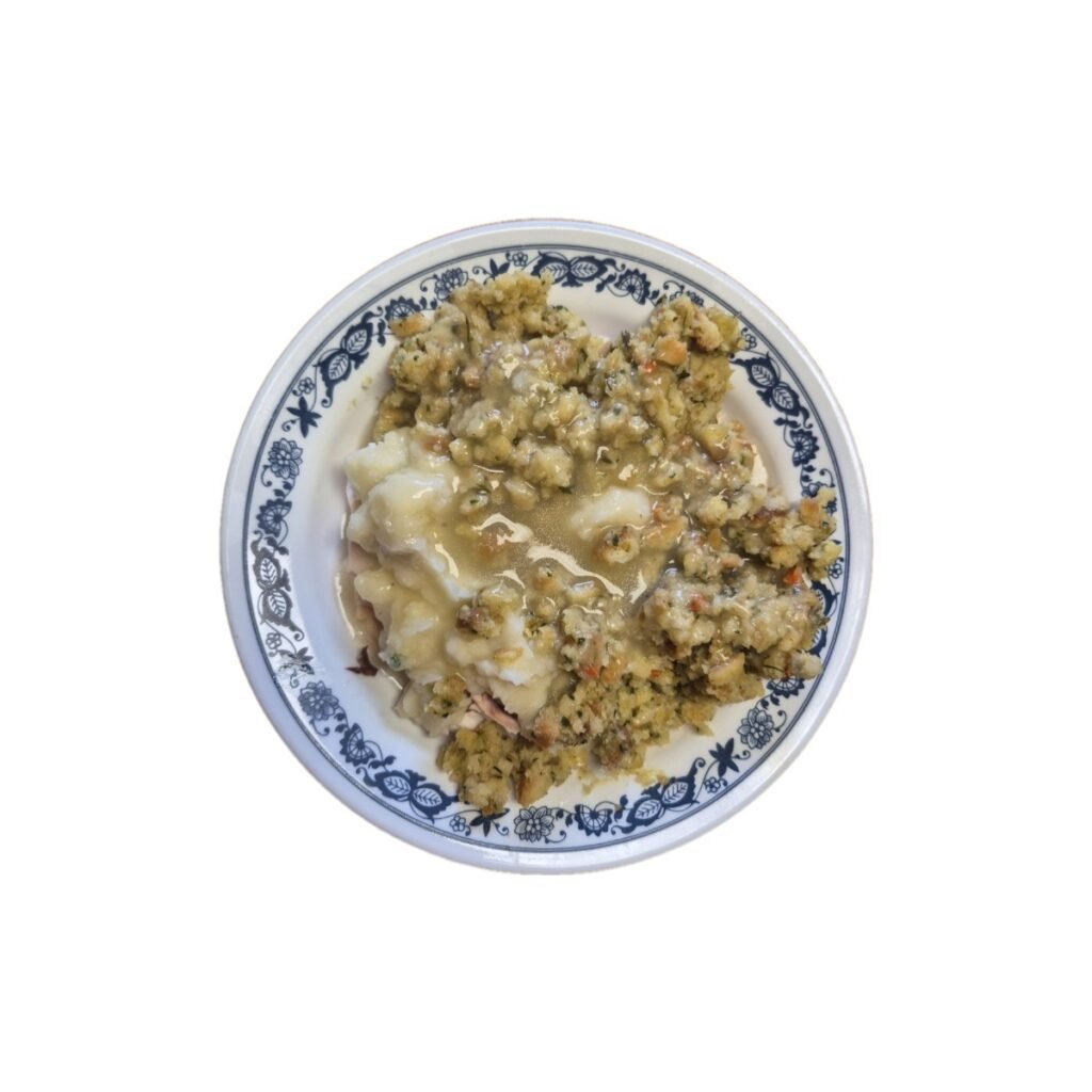Roasted Chicken served with mashed potatoes, stuffing and smothered in gravy