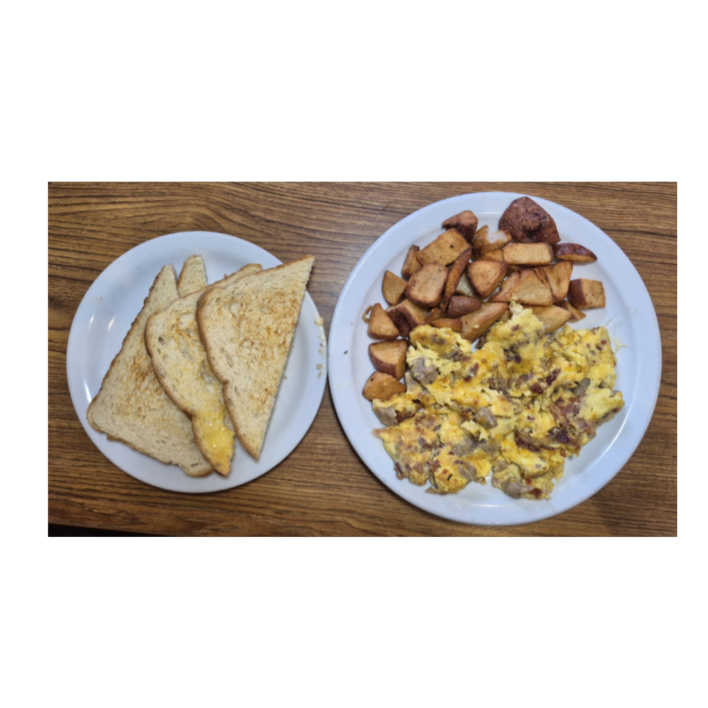 Two‑Meat Scrambler from Denny’s with scrambled eggs, cheese, bacon and sausage, served with toasted sourdough bread