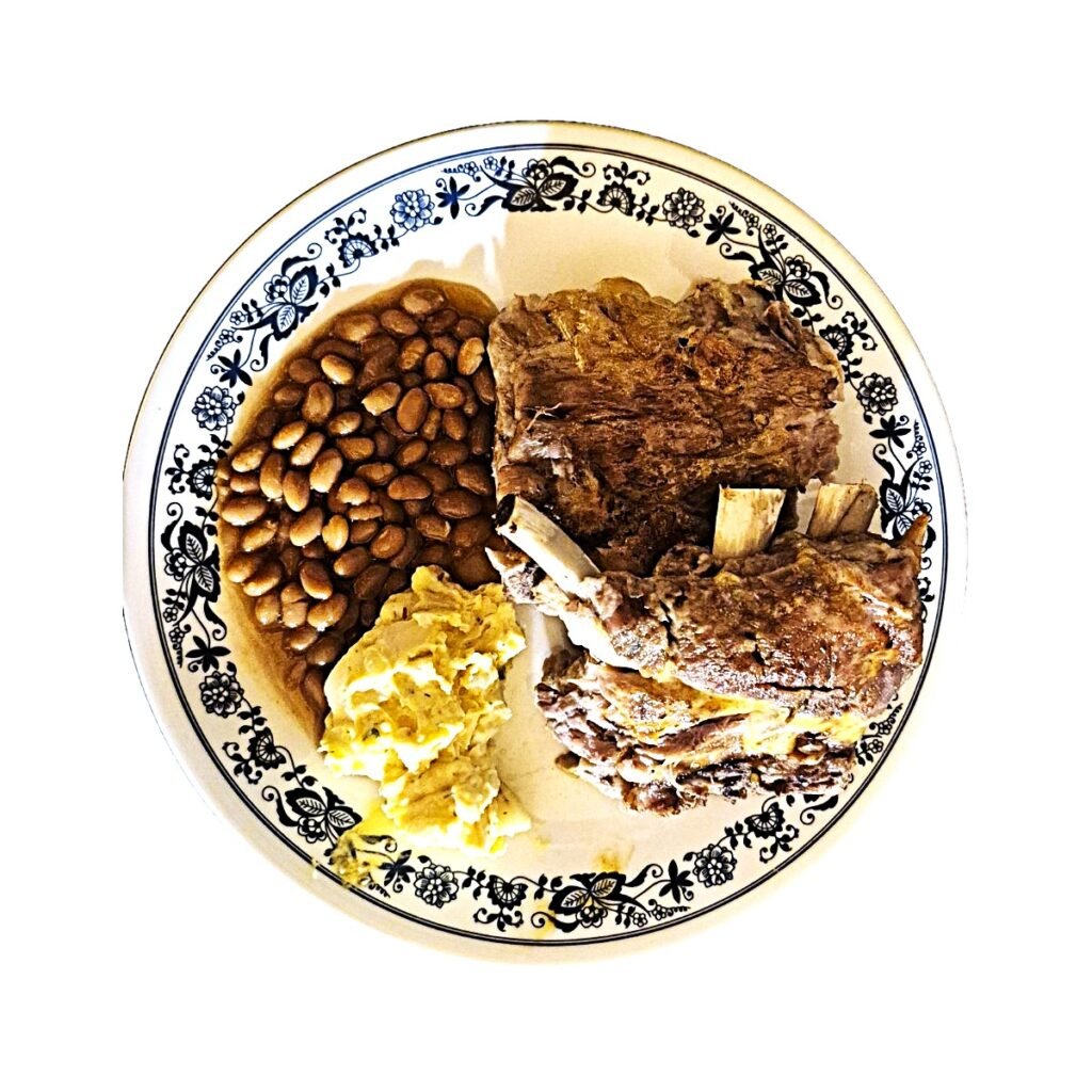Ribs, potato salad and baked beans: 1 Honey mustard baby back ribs, potato salad and baked beans on a blue and white plate